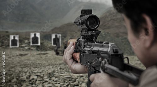 Military soldier shooter aiming ar assault rifle weapon at outdoor academy shooting range
 photo