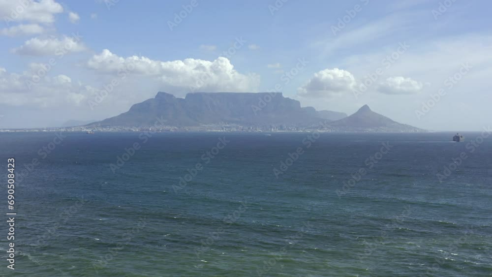 Drone of sea, mountains and sky background for travel on the horizon, nature and empty landscape. Aerial view of sunshine with ocean water, waves and clouds for scenery in Cape Town, South Africa Drone of sea, mountains and sky background for travel on the horizon, nature and empty landscape. Aerial view of sunshine with ocean water, waves and clouds for scenery in Cape Town, South Africa