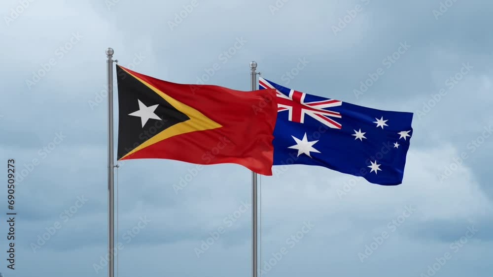 Australia flag and Timor flag waving together on cloudy sky, endless seamless loop, two country relations concept Australia flag and Timor flag waving together on cloudy sky, endless seamless loop, two country relations concept