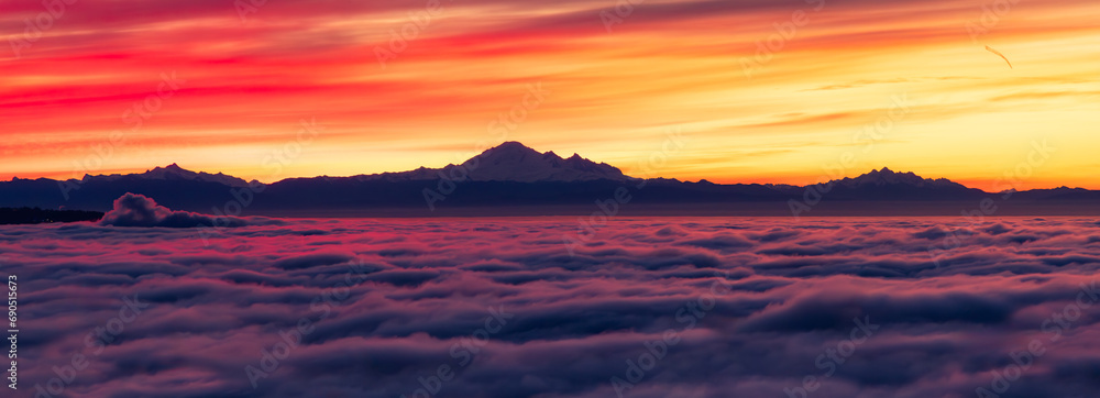 Colorful Sunrise with Vancouver covered in Fog and Mt Baker in Background.