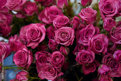 bunch of pink roses. The roses are in full bloom and the petals are a deep pink color close-up