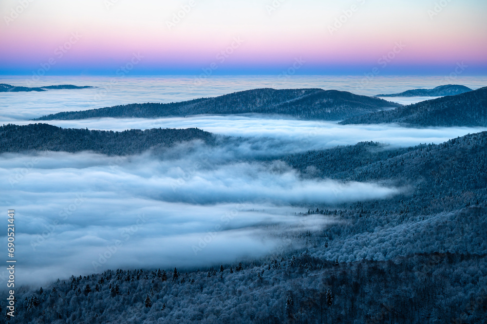 Naklejka premium Beautiful winter mountain landscape. Moody sunset seen from the Mount Smerek in the Bieszczady National Park, Poland.