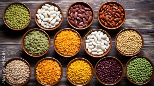  a group of bowls filled with different types of beans and beans next to each other on top of a wooden table.