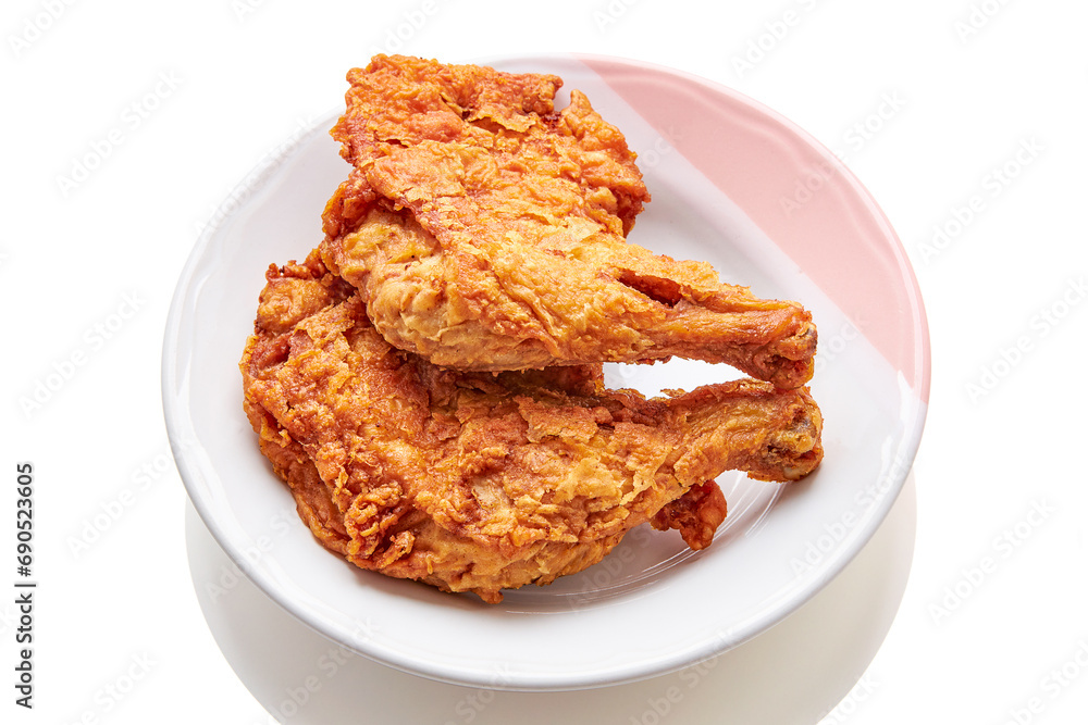 2 large chicken thighs batter and deep fried in plate isolated on white background. fried chicken is a dish consisting of chicken pieces that have been coated with seasoned flour or batter. 2 large chicken thighs batter and deep fried in plate isolated on white background. fried chicken is a dish consisting of chicken pieces that have been coated with seasoned flour or batter.