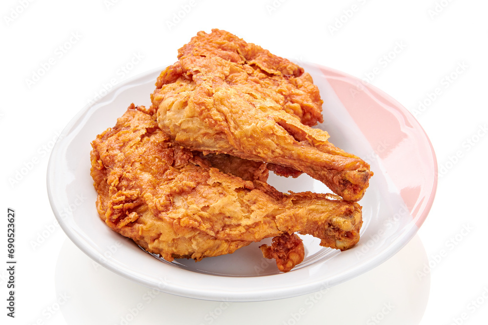 2 large chicken thighs batter and deep fried in plate isolated on white background. fried chicken is a dish consisting of chicken pieces that have been coated with seasoned flour or batter. 2 large chicken thighs batter and deep fried in plate isolated on white background. fried chicken is a dish consisting of chicken pieces that have been coated with seasoned flour or batter.
