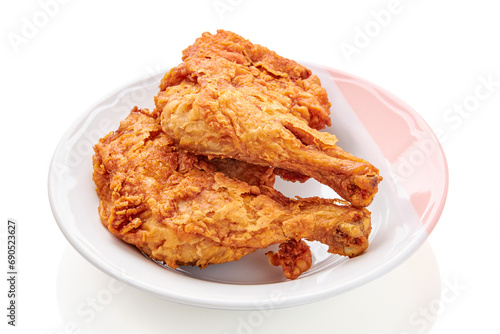 2 large chicken thighs batter and deep fried in plate isolated on white background. fried chicken is a dish consisting of chicken pieces that have been coated with seasoned flour or batter.