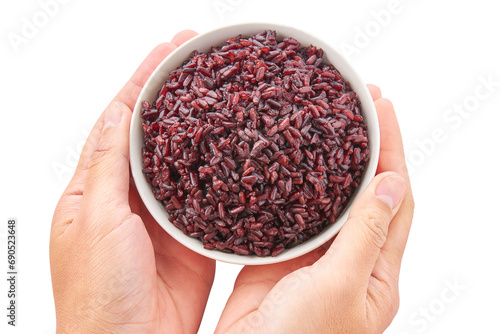 Hand holding white bowl of cooked riceberry isolated on white background. Riceberry rice is dark purple rice similar to ripe berries, rich in nutrients and has good anti-oxidant properties.