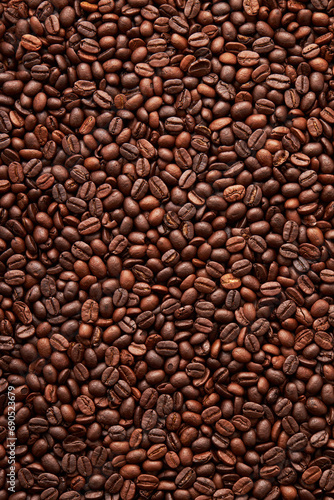 Top view of roasted coffee beans background on flat lay in vertical, surface, texture, Roasted coffee beans is a fruit from the Coffee plant. This fruit is often referred to as a coffee cherry.