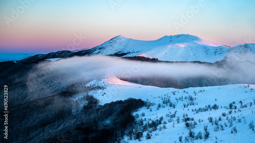 Fototapeta Naklejka Na Ścianę i Meble -  Beautiful winter mountain landscape. Moody sunset seen from the Mount Smerek in the Bieszczady National Park, Poland.