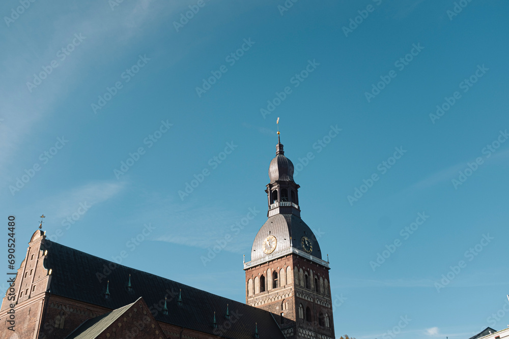 Beautiful old brick cathedral with high tower peak famous landmark in Riga, Latvia