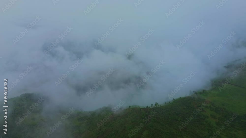 Mountain and forest landscape with clouds with aerial view from drone. Fog clouds cover the mountains and forests. Mountain and forest landscape with clouds with aerial view from drone. Fog clouds cover the mountains and forests.