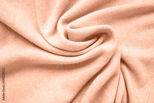Cashmere scarf texture. Top view, close-up. Peach fuzz is color of year 2024.