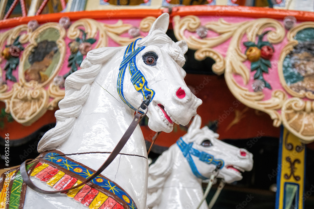 white wooden horses on a merry-go-round