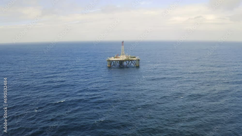 Oil, rig and drone in landscape with ocean, industry and mining offshore with drill on platform. Industrial, fuel and extraction of petrol in sea, field and water with blue sky, clouds or horizon Oil, rig and drone in landscape with ocean, industry and mining offshore with drill on platform. Industrial, fuel and extraction of petrol in sea, field and water with blue sky, clouds or horizon