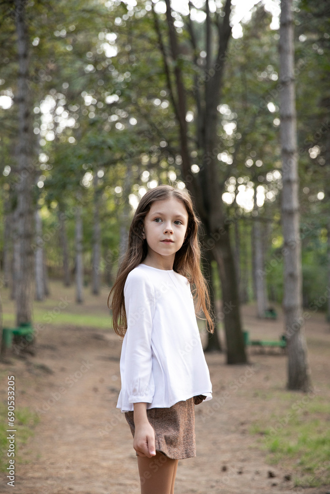 Profile portrait of a pretty little girl, posing in the park. Profile portrait of a pretty little girl, posing in the park.