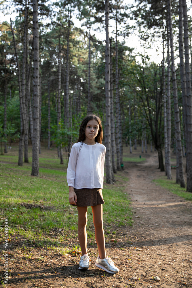 Cute shy little girl in a elegant clothesposing in park. Cute shy little girl in a elegant clothesposing in park.