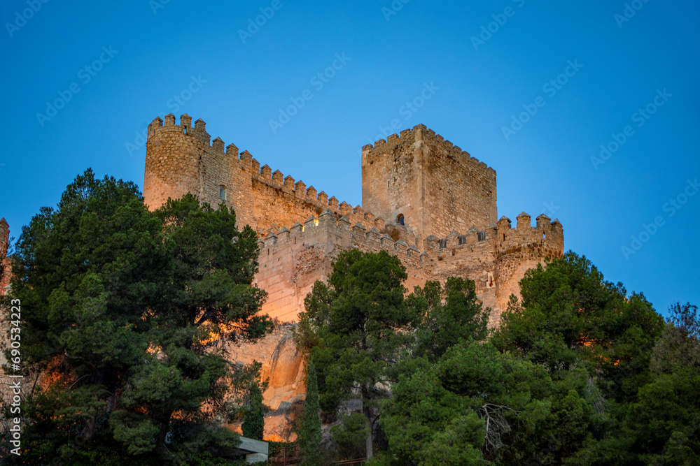 Imposing view of Almansa Castle, Albacete, Castilla La Mancha, Spain with artificial lighting at dawn