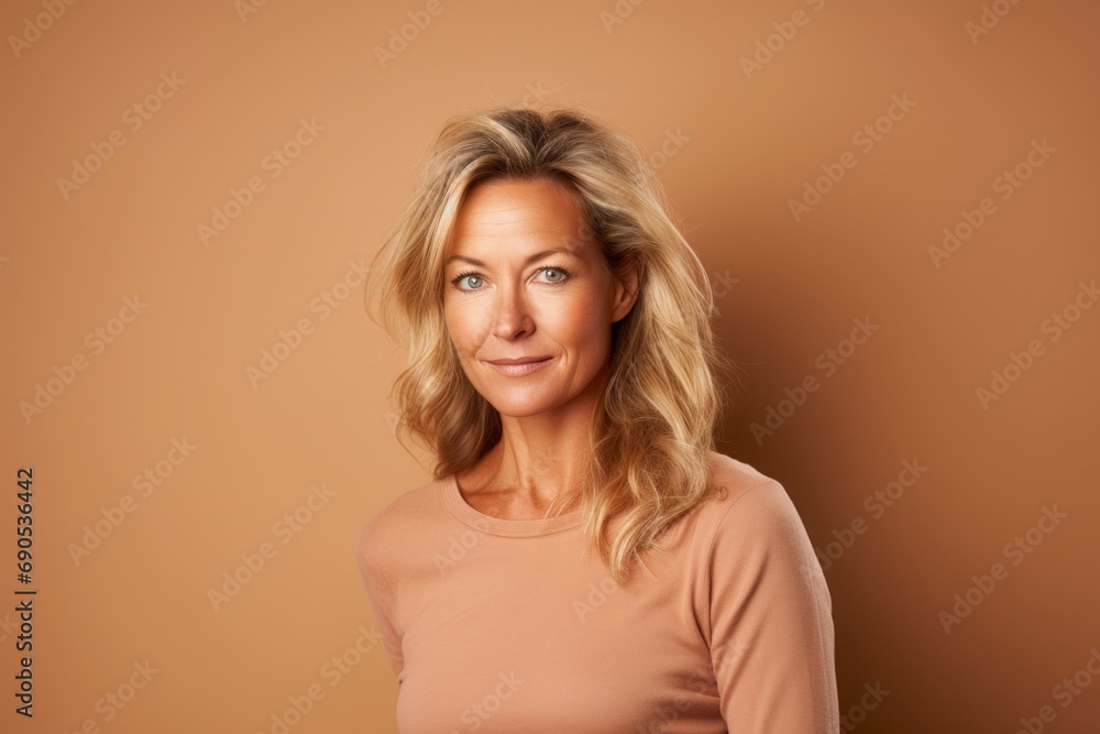 Portrait of a beautiful middle-aged woman on a brown background Portrait of a beautiful middle-aged woman on a brown background