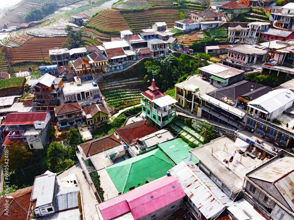 Naklejka premium The beauty of the landscape Leek and vegetable plantations and architecture of the arrangement of terraced houses in the tourist area of ​​Nepal van Java, Butuh Hamlet, Magelang, indonesia 
