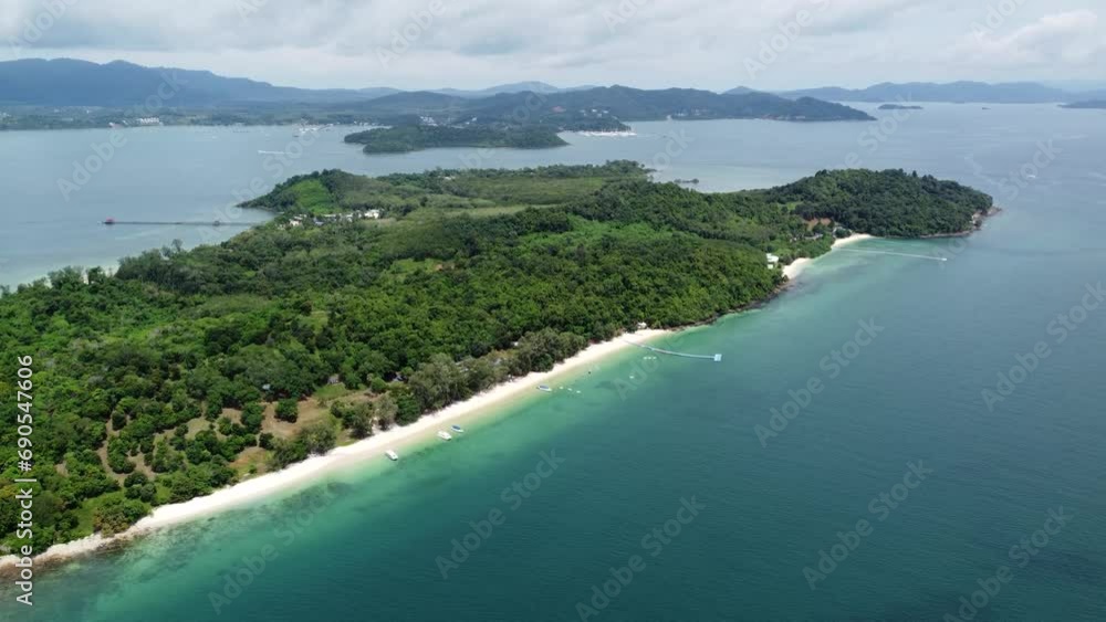 Aerial drone view of Ko Naka Yai a tropical island near the coast of Thailand Phuket showing the white beaches and trees and the mountains in the far background on mainland 4k high resolution quality Aerial drone view of Ko Naka Yai a tropical island near the coast of Thailand Phuket showing the white beaches and trees and the mountains in the far background on mainland 4k high resolution quality