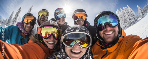 Many happy cheering friends, group of people wearing ski equipment, taking selfies outdoors under the bright winter sun. photo