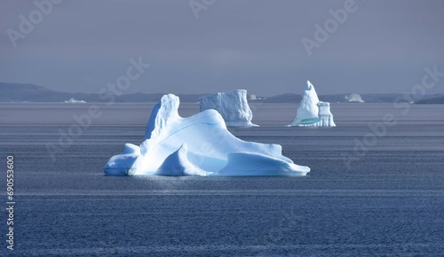  icebergs and  distant islands,  near nanortalik near tasermiut fjord  in southern greenland, on a  cruise ship in summer photo
