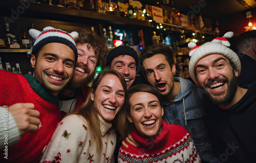 large group of people wearing christmas sweaters taking selfies