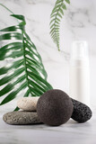 Konjac facial sponge and foam for washing, a leafy green background enhancing the eco-friendly skincare