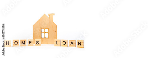 Home loans- word composed fromwooden blocks letters on White background, wooden house symbol. copy space for ad text. Banner. photo