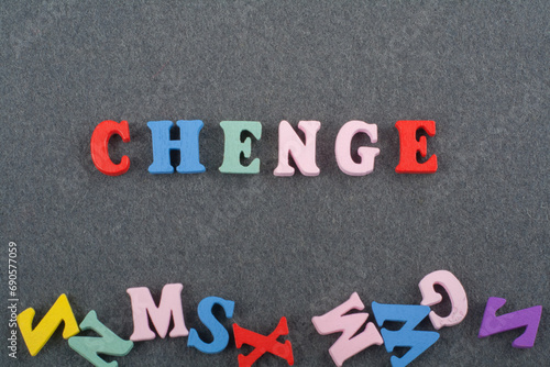 CHENGE word on black board background composed from colorful abc alphabet block wooden letters, copy space for ad text. Learning english concept.