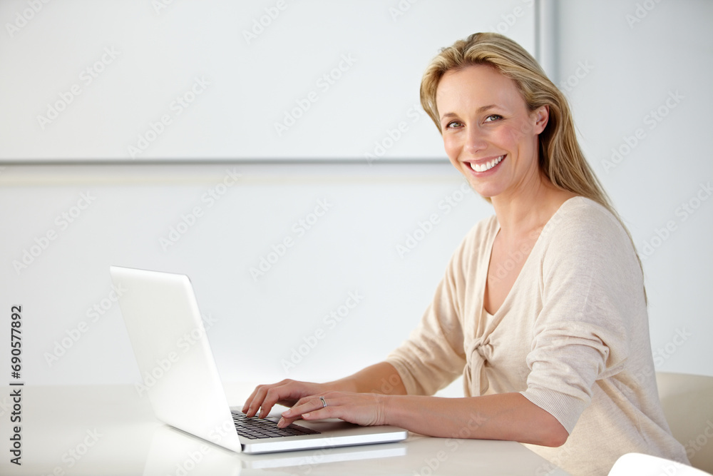 Business woman, laptop or portrait with smile at desk for online research, website review or planning social network connection in creative startup. Happy mature employee typing on computer in agency Business woman, laptop or portrait with smile at desk for online research, website review or planning social network connection in creative startup. Happy mature employee typing on computer in agency