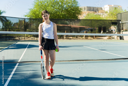 Beautiful happy teen girl having fun playing tennis