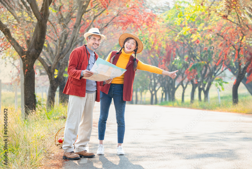 Fototapeta premium senior man father and young woman daughter standing by the street,find a location on a map for travel in the city
