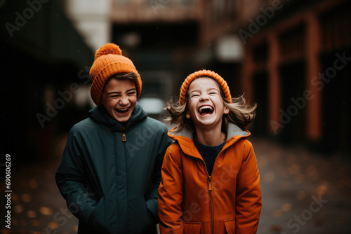 Happy brother and sister enjoying fun, laughter and togetherness outdoors during the cold winter season.