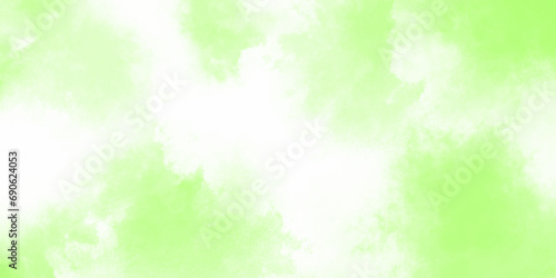 Green watercolor background. Creative green and yellow shades hand drawn texture. Soft blurred fog or haze in sunlight sky Beautiful abstraction of liquid paints in slow blending flow mixing