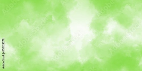 Green watercolor background. Creative green and yellow shades hand drawn texture. Soft blurred fog or haze in sunlight sky Beautiful abstraction of liquid paints in slow blending flow mixing