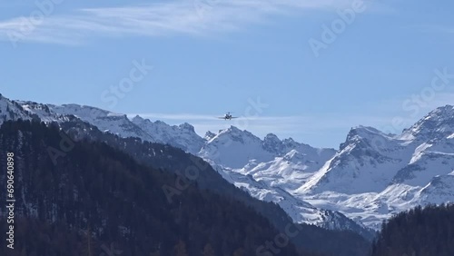 Private Jet Silhouette Generic Final Approach for landing at Mountain valley regional winter frozen cold skiing airport sankt moritz switzerland snow photo