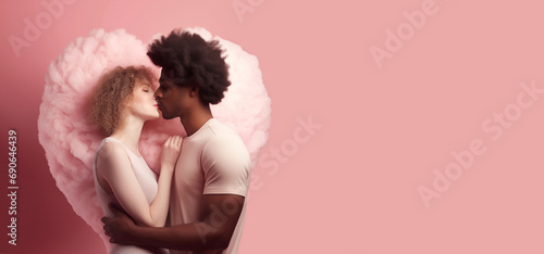 Valentine's day concept. A young couple embracing. An African-American man and a European girl. They kiss gently in rapture in front of a heart-shaped cloud of soft pink color. Background pastel pink  photo