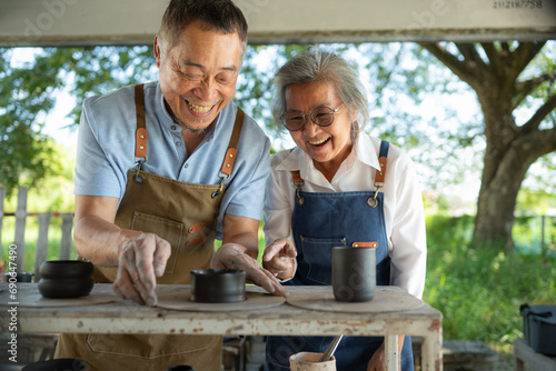 Obraz na plátně Portrait of a senior Asian couple doing activities together in the pottery workshop