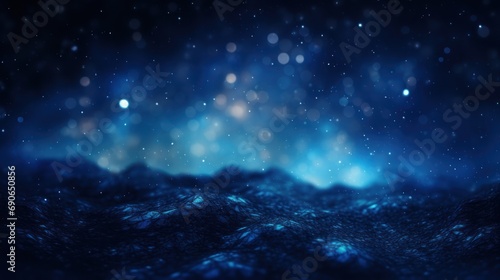 Abstract background of dark blue particles and soft blurred glow.