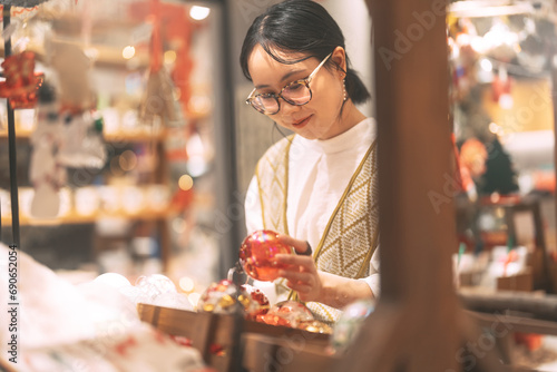 Asian woman choosing gift shop on Christmas and happy new year holidays