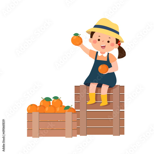 Little girl sitting on wooden nearby boxes with the harvest of the oranges