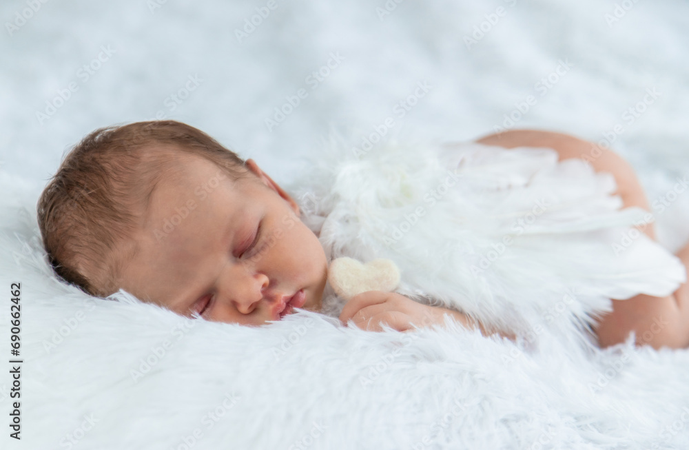 Newborn angel photo session in a suit. Selective focus Newborn angel photo session in a suit. Selective focus