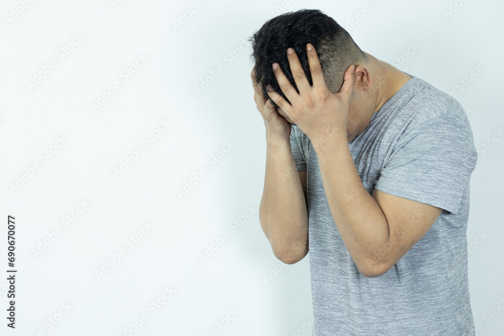 Portrait of Depressed Asian Man hiding his face with hands. Stressed, Hopeless, Frustration, Mental disorder, Broken heart and Psychological problems. Portrait of Depressed Asian Man hiding his face with hands. Stressed, Hopeless, Frustration, Mental disorder, Broken heart and Psychological problems.