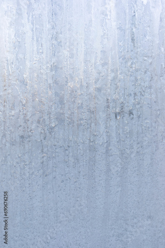 Frosty winter striped pattern on winter window glass. Magic of nature. Vertical image. Copy space.