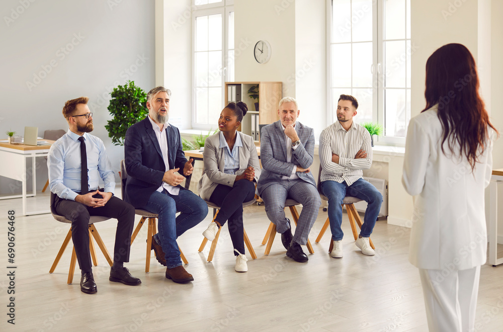 African American woman speaker giving talk at business meeting in office. Female trainer, leader consulting clients, explaining strategy, teaching employees team during workshop
