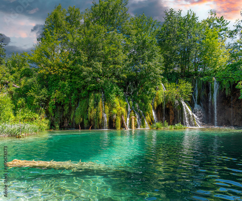 Picturesque waterfall. Waterfall among rocks and forest. Plitvice Lakes  Croatia.
