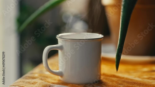 Hot coffee mug in the morning. Delicious drink to start the day. Steaming hot beverage.