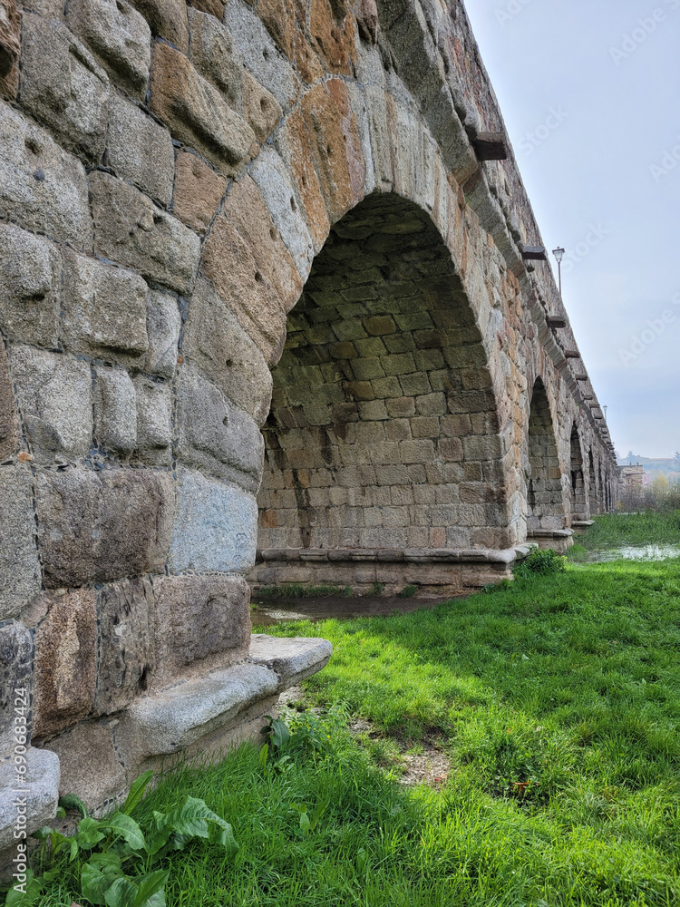 side view of the arches of the Roman bridge over the Tormes river in Salamanca