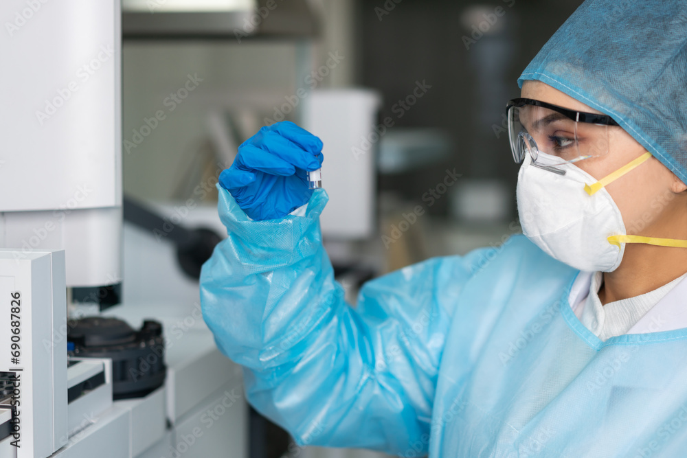 Female scientist looking at the scientific sample in the laboratory Female scientist looking at the scientific sample in the laboratory